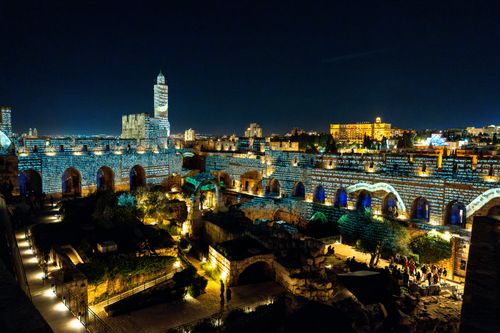 Free Spectacular night view of the Tower of David in Jerusalem, illuminated by vibrant projections. Stock Photo
