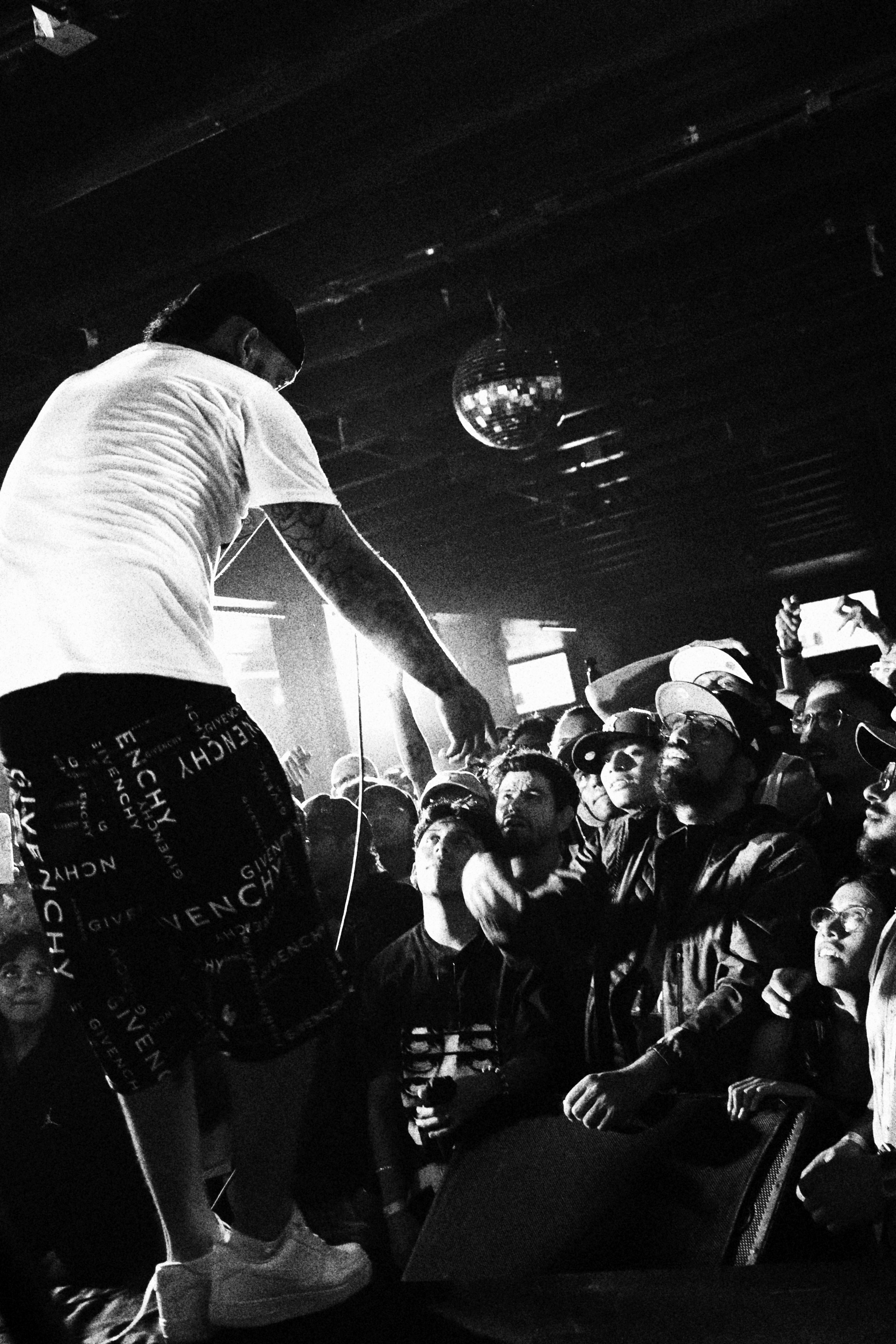 Black and white photo capturing the energy of a live concert performance.