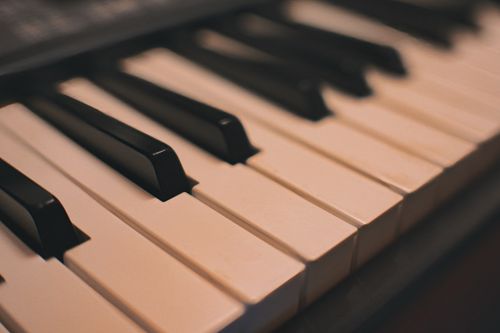 Free Elegant close-up of piano keys with warm lighting, perfect for music-themed projects. Stock Photo