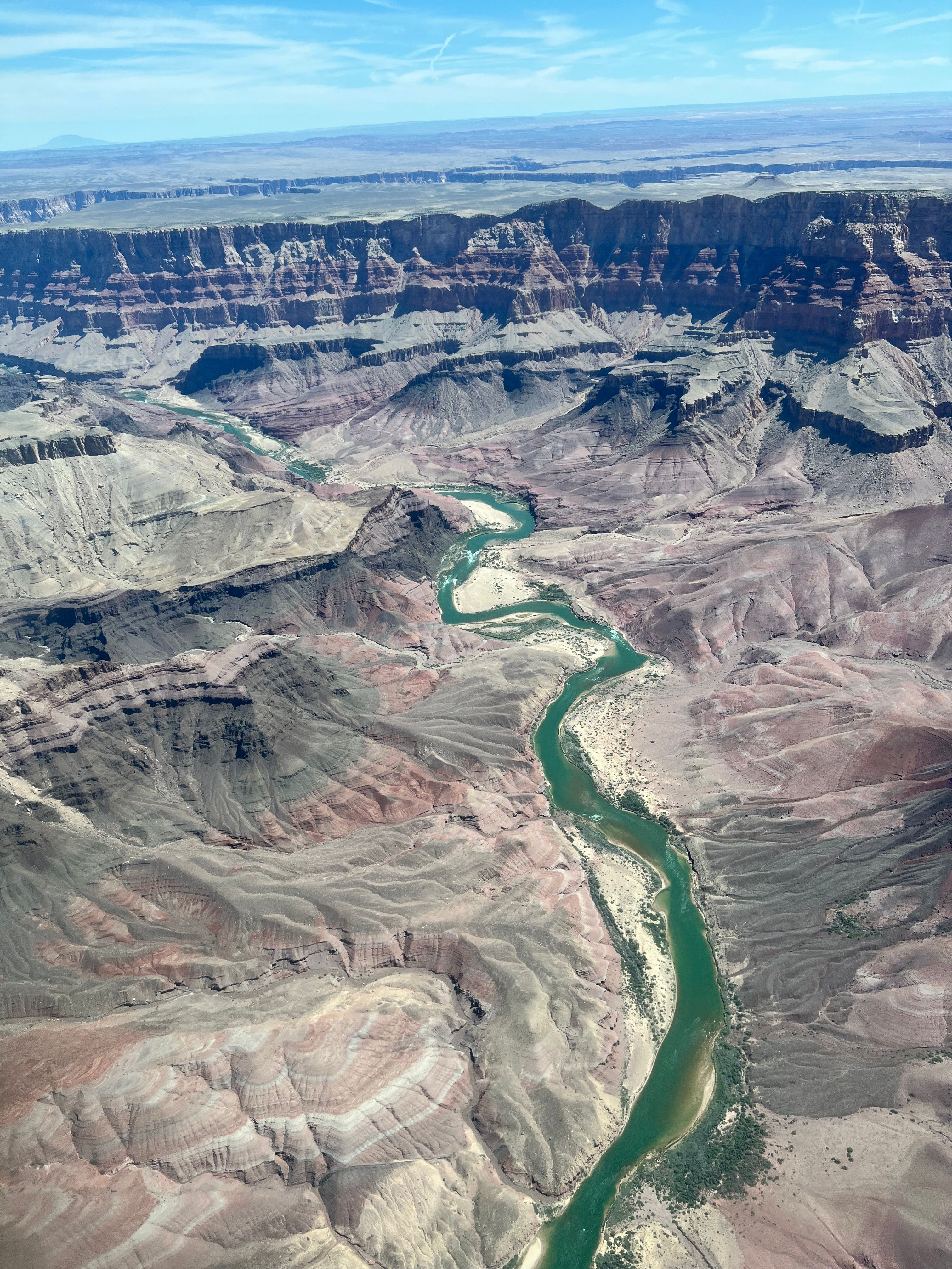 Stunning aerial view of the Grand Canyon showcasing the winding Colorado River under a clear sky