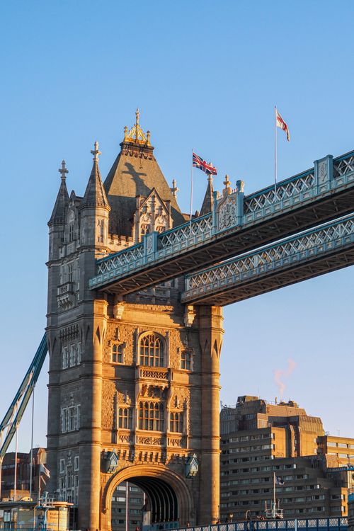 Free Captivating view of the Tower Bridge in London, England, beautifully lit by the setting sun, under a clear blue sky. Stock Photo