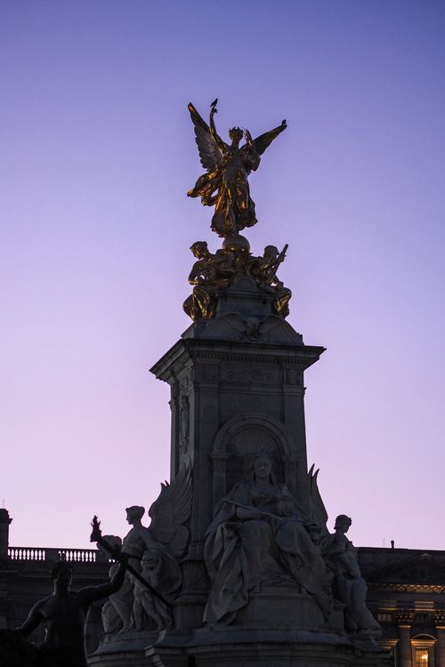 Free The Victoria Memorial in London silhouetted against a vibrant sunset sky. Stock Photo