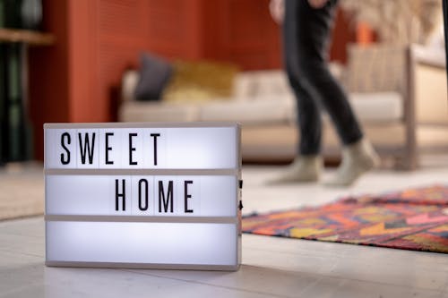 Lit up Sign on Floor of Living Room