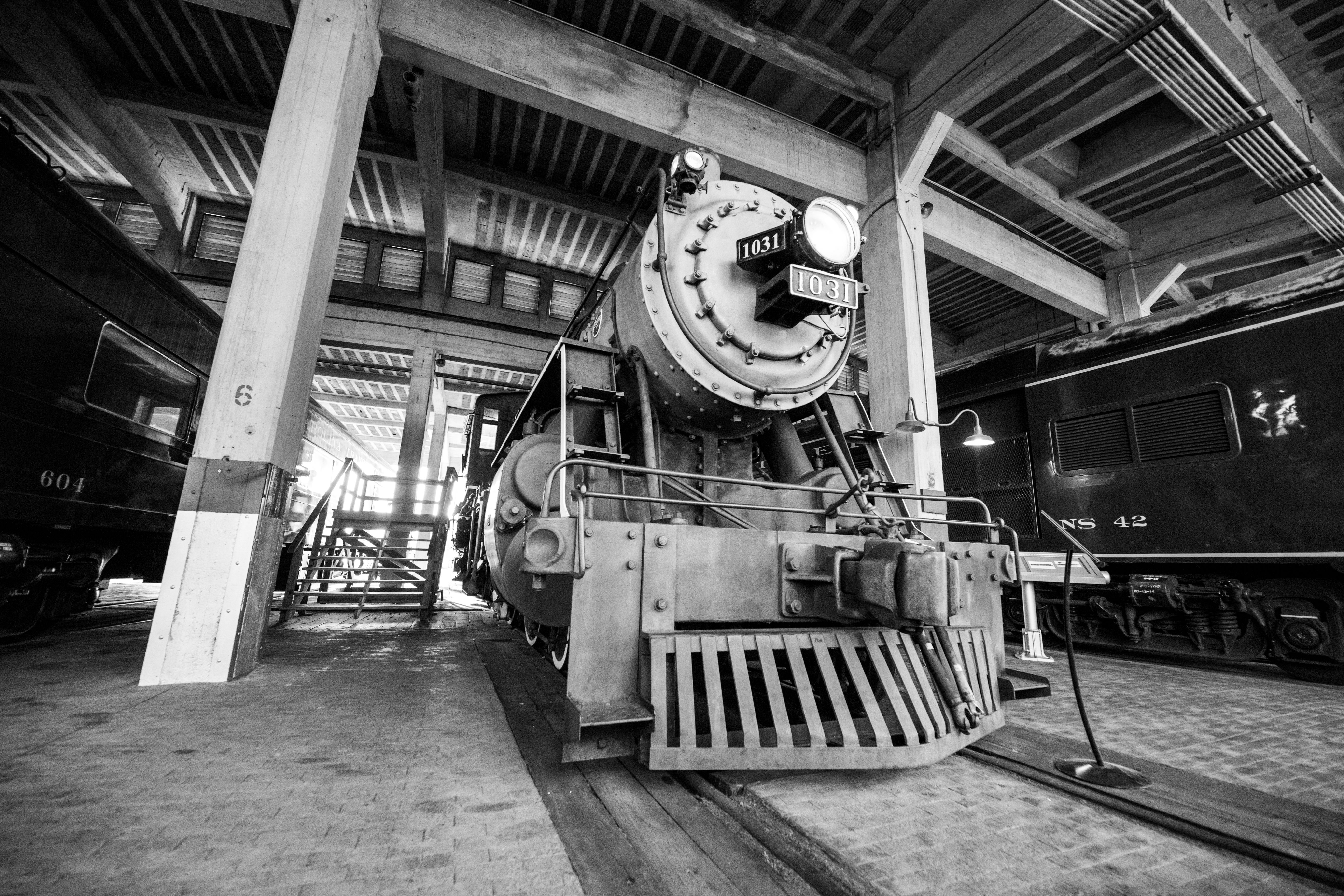 A vintage steam locomotive displayed at a historic train depot