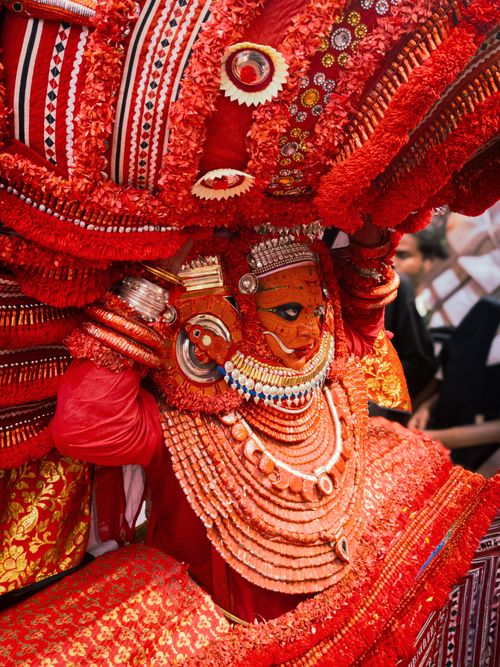 Free Stunning Theyyam performer in vibrant red attire during a traditional festival in Kerala, India. Stock Photo