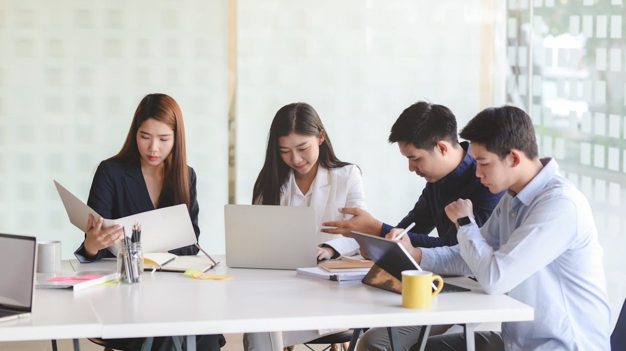 Ethnic colleagues working on project in modern office