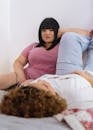 Thoughtful women chilling together on bed