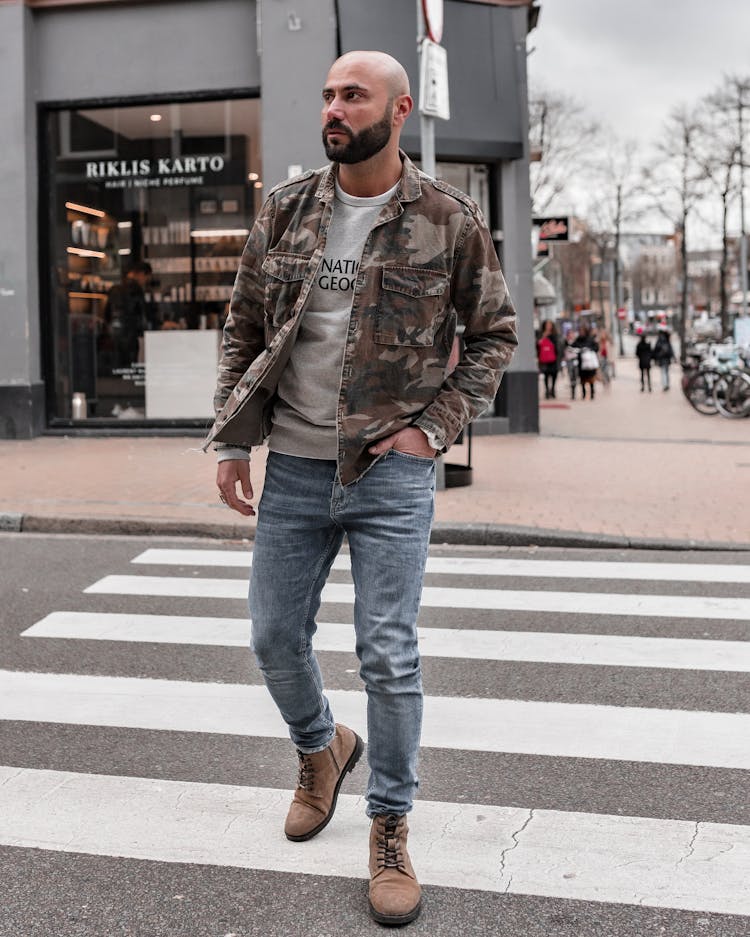 Man In Brown Leather Jacket And Blue Denim Jeans Walking On Crosswalk