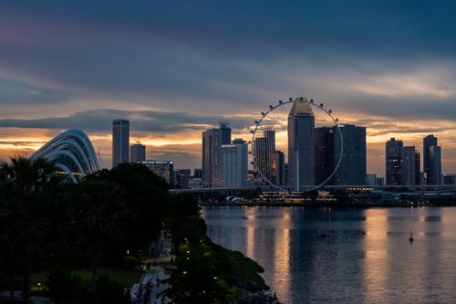 Free Stunning view of Singapore skyline featuring the iconic Ferris wheel and modern skyscrapers during twilight. Stock Photo