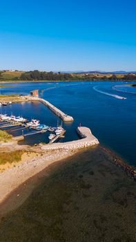 Aerial photograph capturing a tranquil harbor on a sunny summer day, perfect for travel enthusiasts.