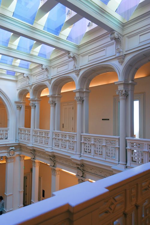 Free Luxurious interior hallway featuring classic European architectural design with arches and columns. Stock Photo