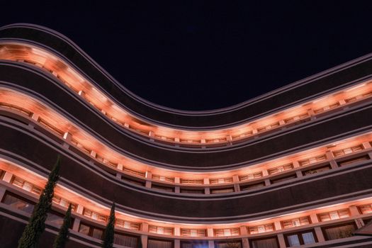 Stunning modern architecture with warm lighting against a night sky. Perfect for architecture and design themes.