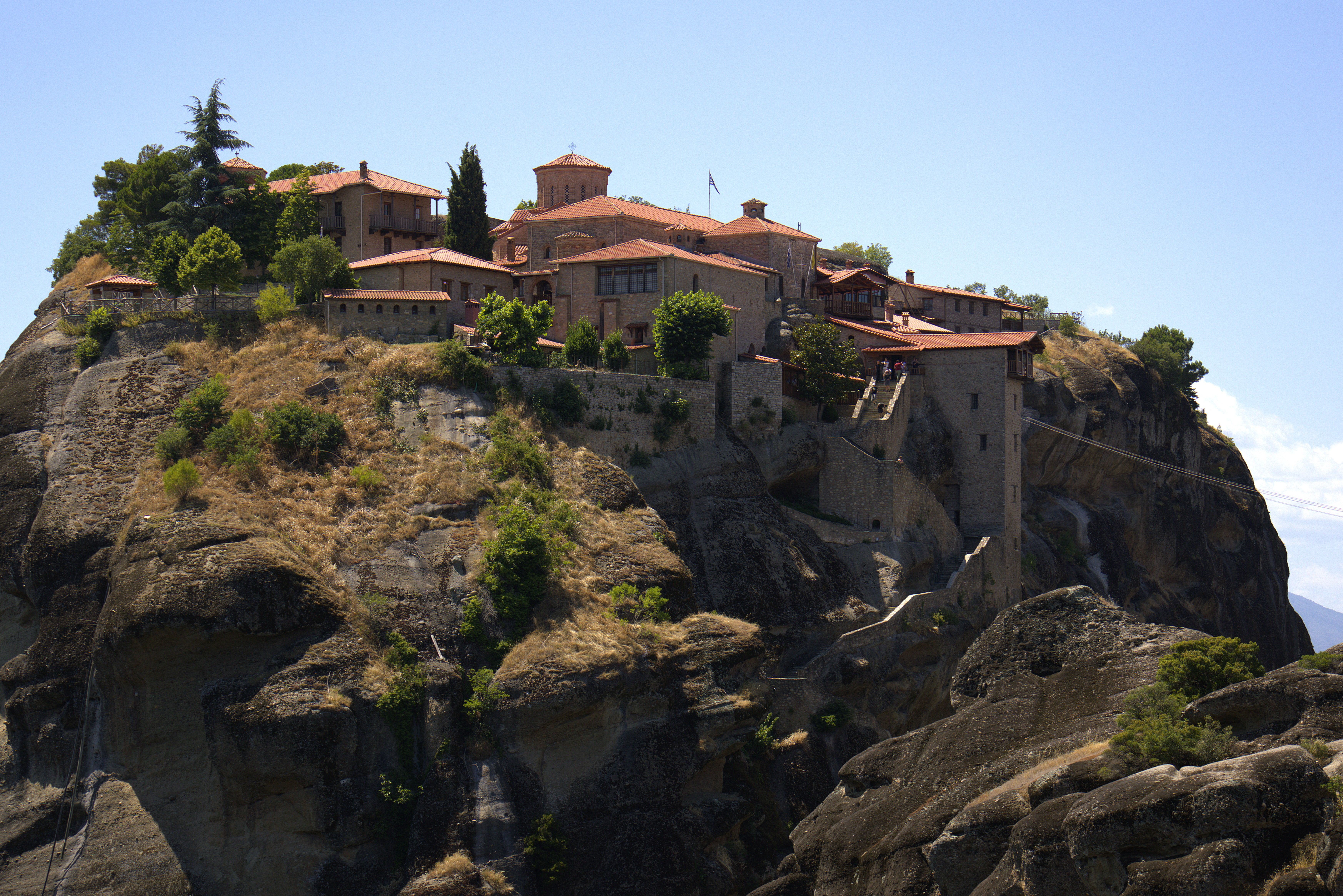 Stunning view of Meteora monastery perched on rocky cliff in Greece.