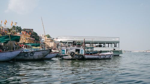Free Traditional boats docked along the Ganges River in Varanasi, capturing the essence of Indian river life. Stock Photo