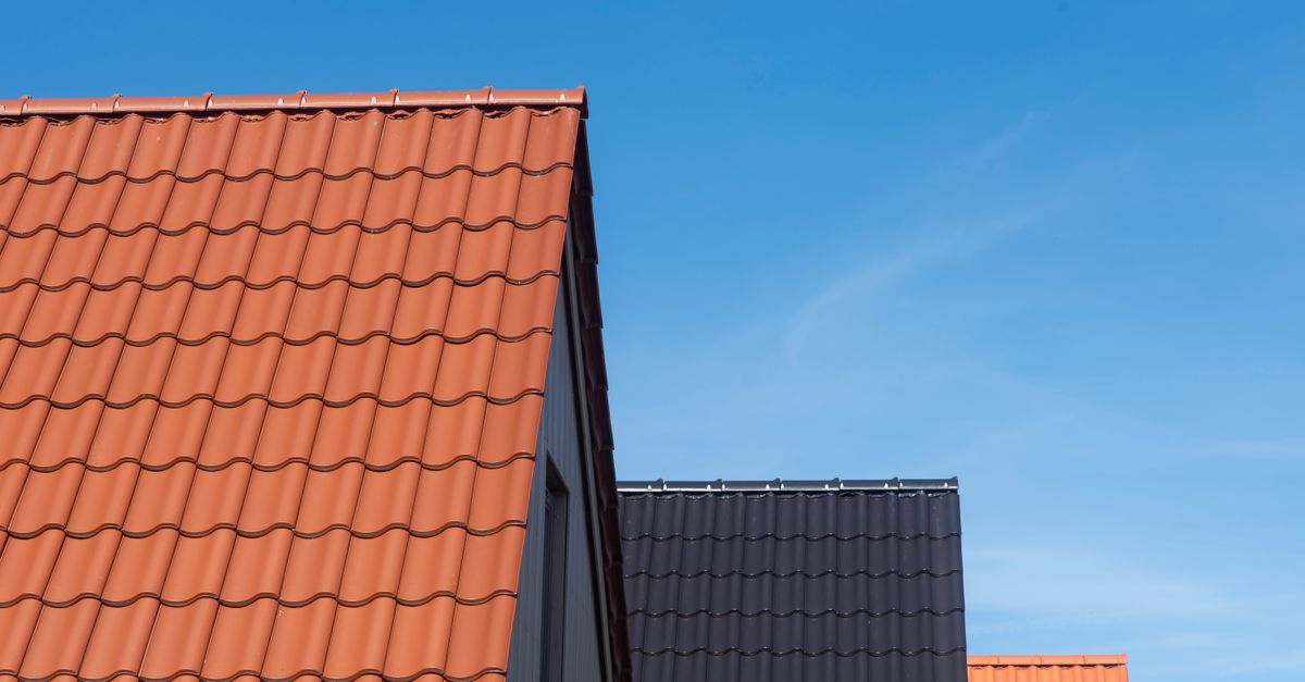 Vibrant rooftops contrasting with clear blue sky, showcasing architecture.