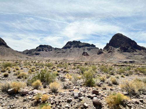 Free Vast desert landscape with rocky mountains under a bright sky. Stock Photo