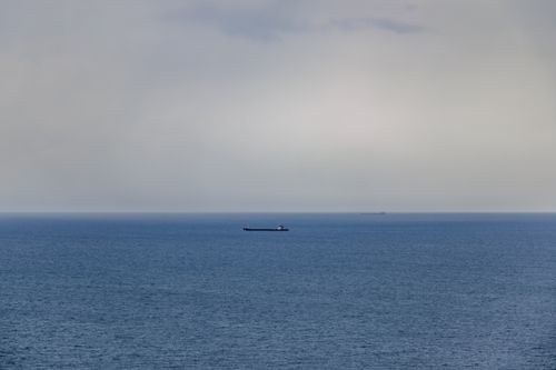 Free A serene view of the sea with a lone cargo ship near Zonguldak, Türkiye. Stock Photo