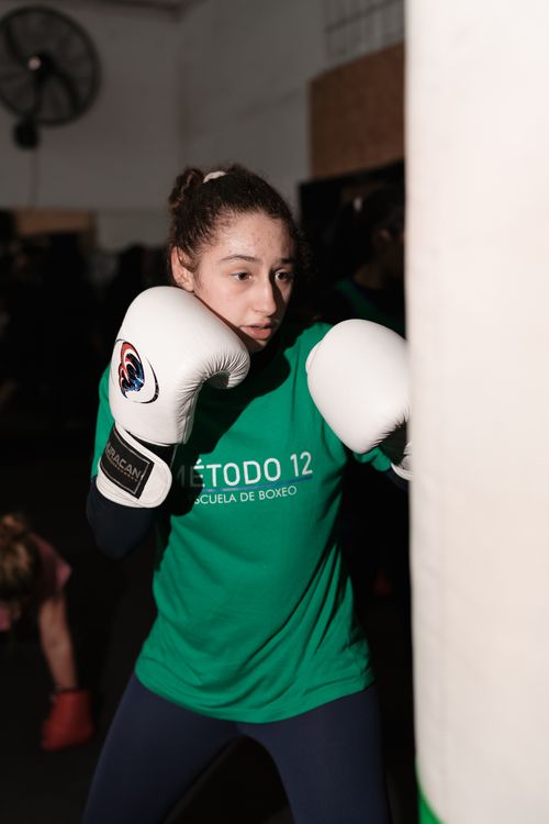 Free A dedicated young woman practices boxing with focus at an indoor gym in Buenos Aires. Stock Photo