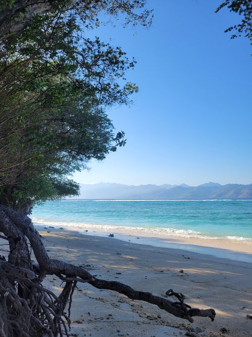 Free Tranquil beach scene with clear waters in West Nusa Tenggara, Indonesia under a clear blue sky. Stock Photo
