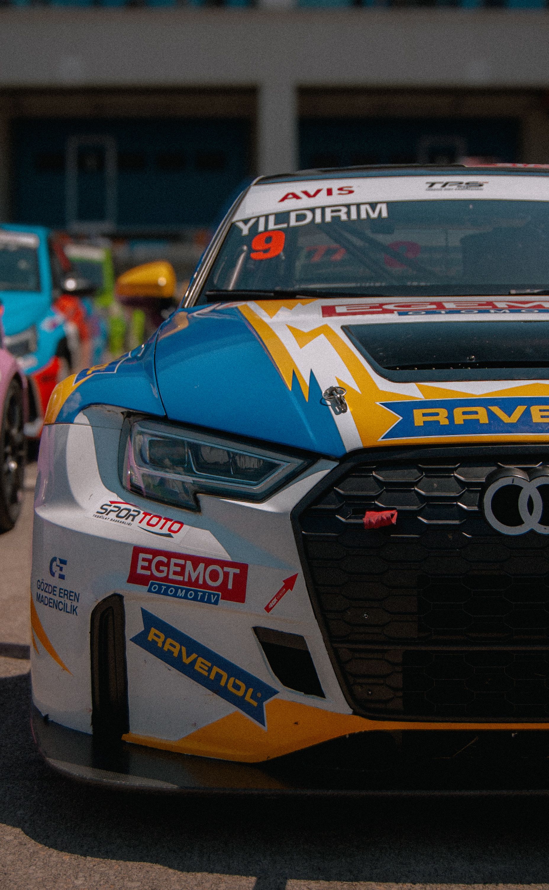 Dynamic front view of racing cars lined up at an İstanbul circuit under clear daylight.