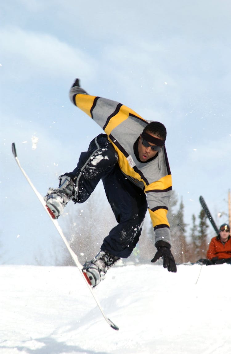 Man Riding A White Snowboard During Daytime