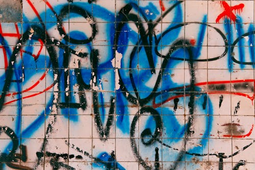 Free Colorful graffiti on wall covered with tile Stock Photo