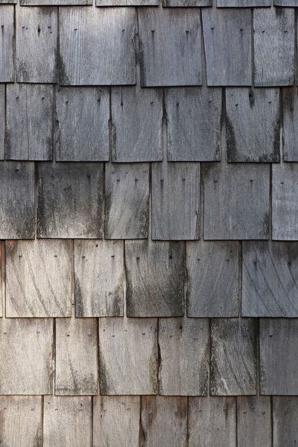 Close-up of rustic wooden shingles showcasing natural texture and wear.
