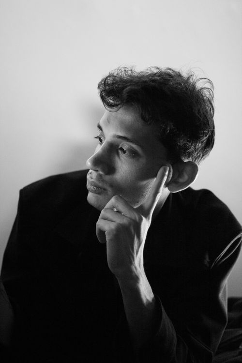 Free Black and white portrait of a young man in deep thought, highlighting emotion. Stock Photo