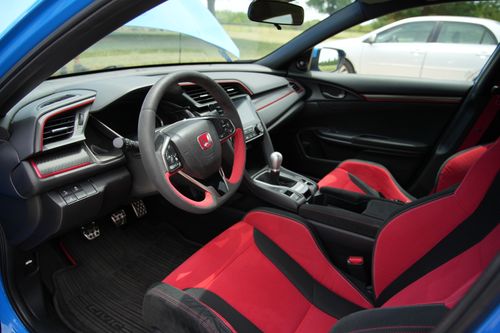 Free Explore the sleek interior of a Honda Civic Type R featuring sporty red accents and a modern dashboard. Stock Photo