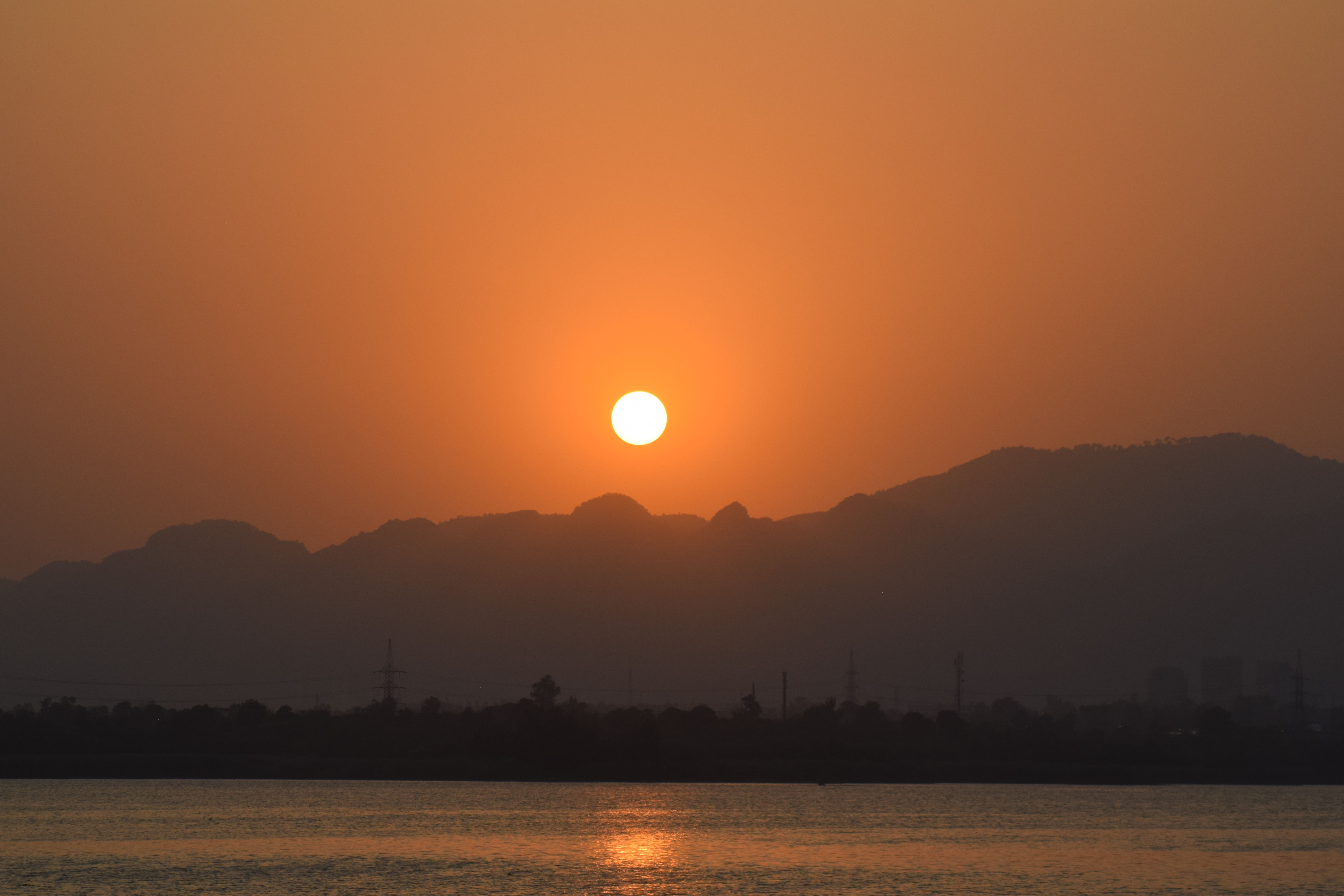 sunrise over a peaceful cityscape, soft light, from a quiet viewpoint
