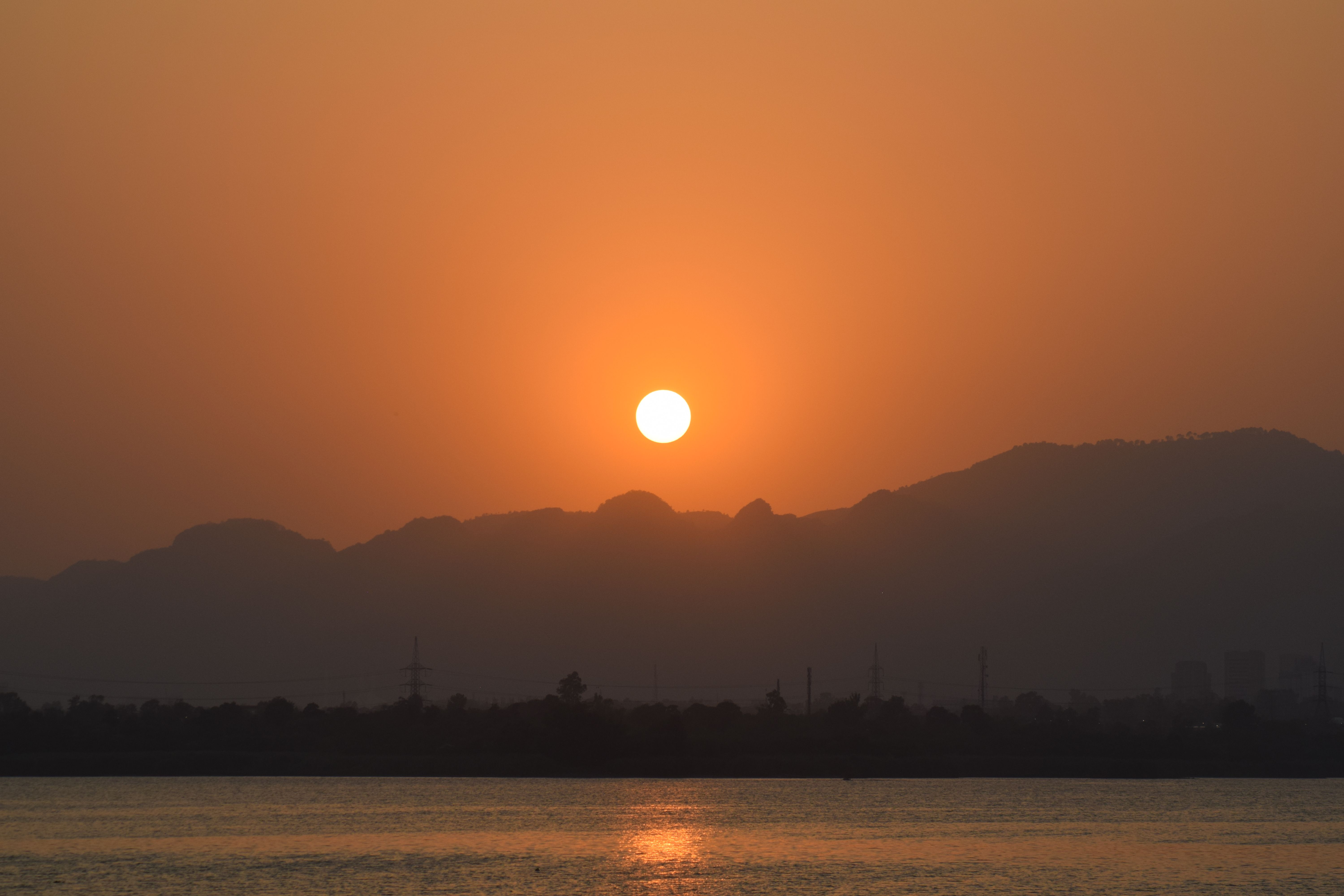 Dust-obscured sun over the Theban hills during a khamsin wind