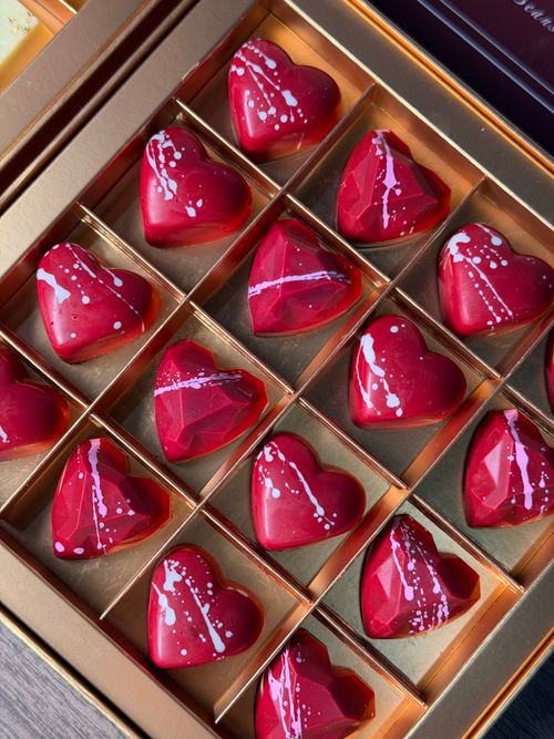 Free Luxurious heart-shaped chocolates with artistic design, perfect for special occasions. Stock Photo