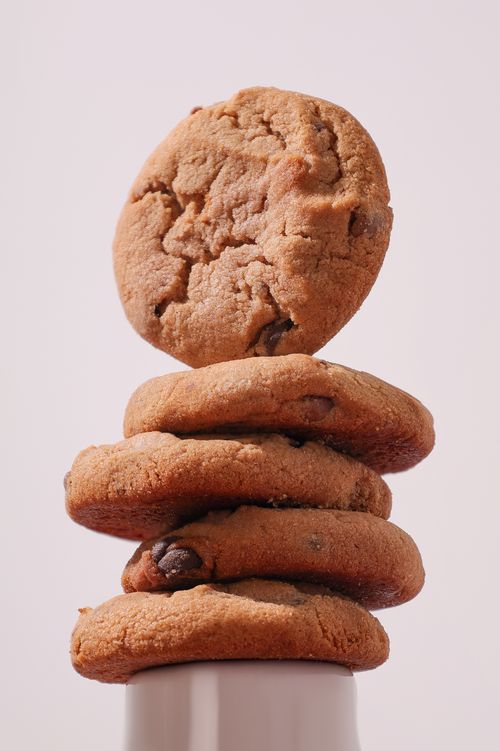 Free A stack of freshly baked chocolate chip cookies isolated on a light background. Stock Photo