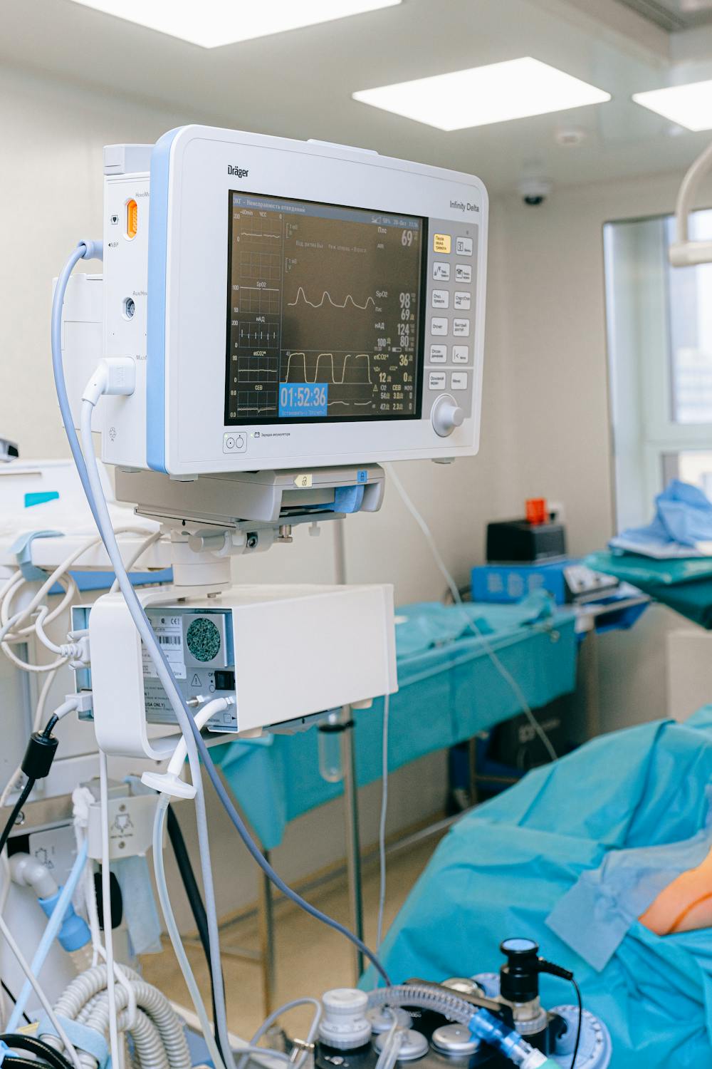 A hospital room with a bed and ECG monitor