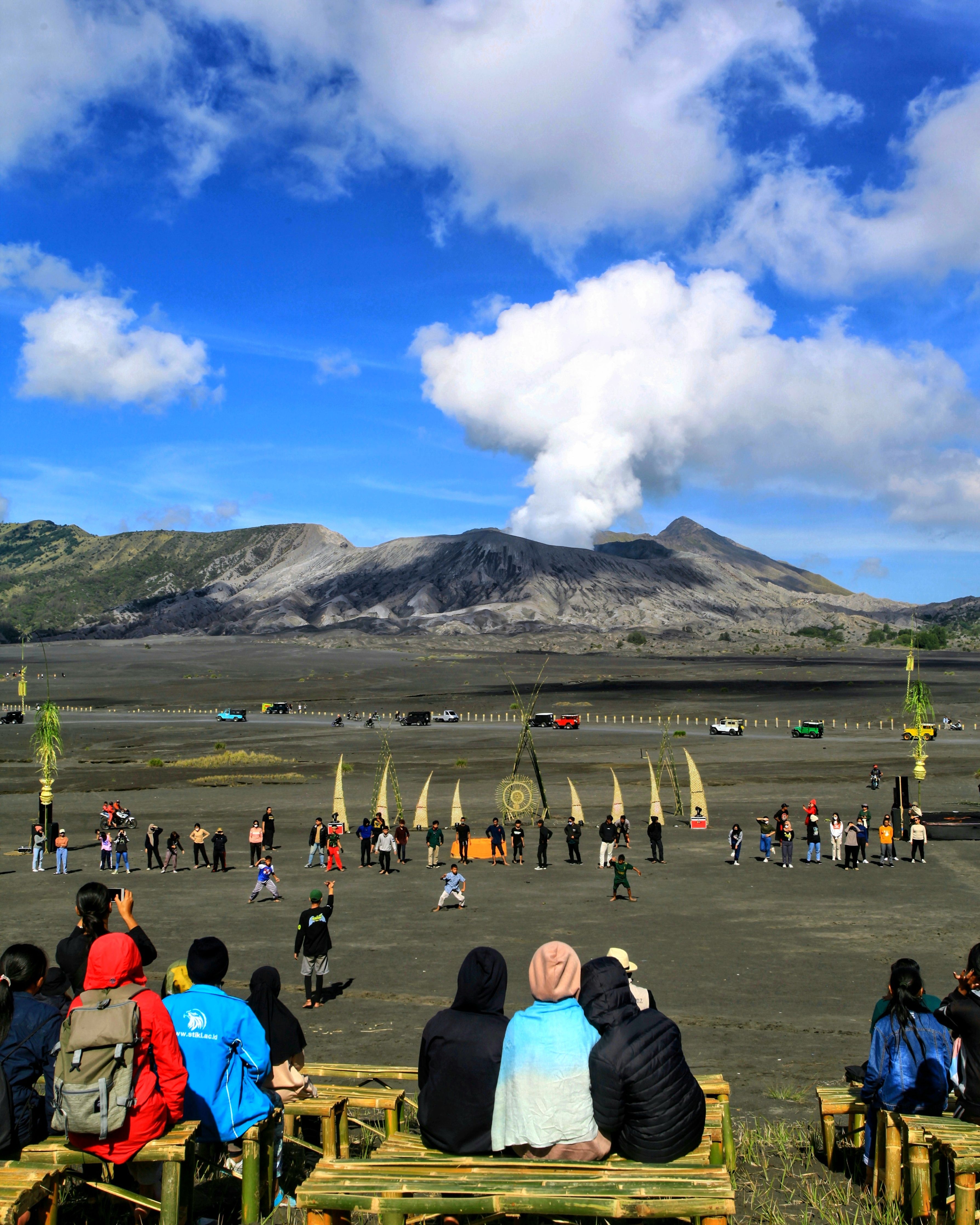 Vibrant festival scene with people gathered at Mount Bromo, East Java, Indonesia.
