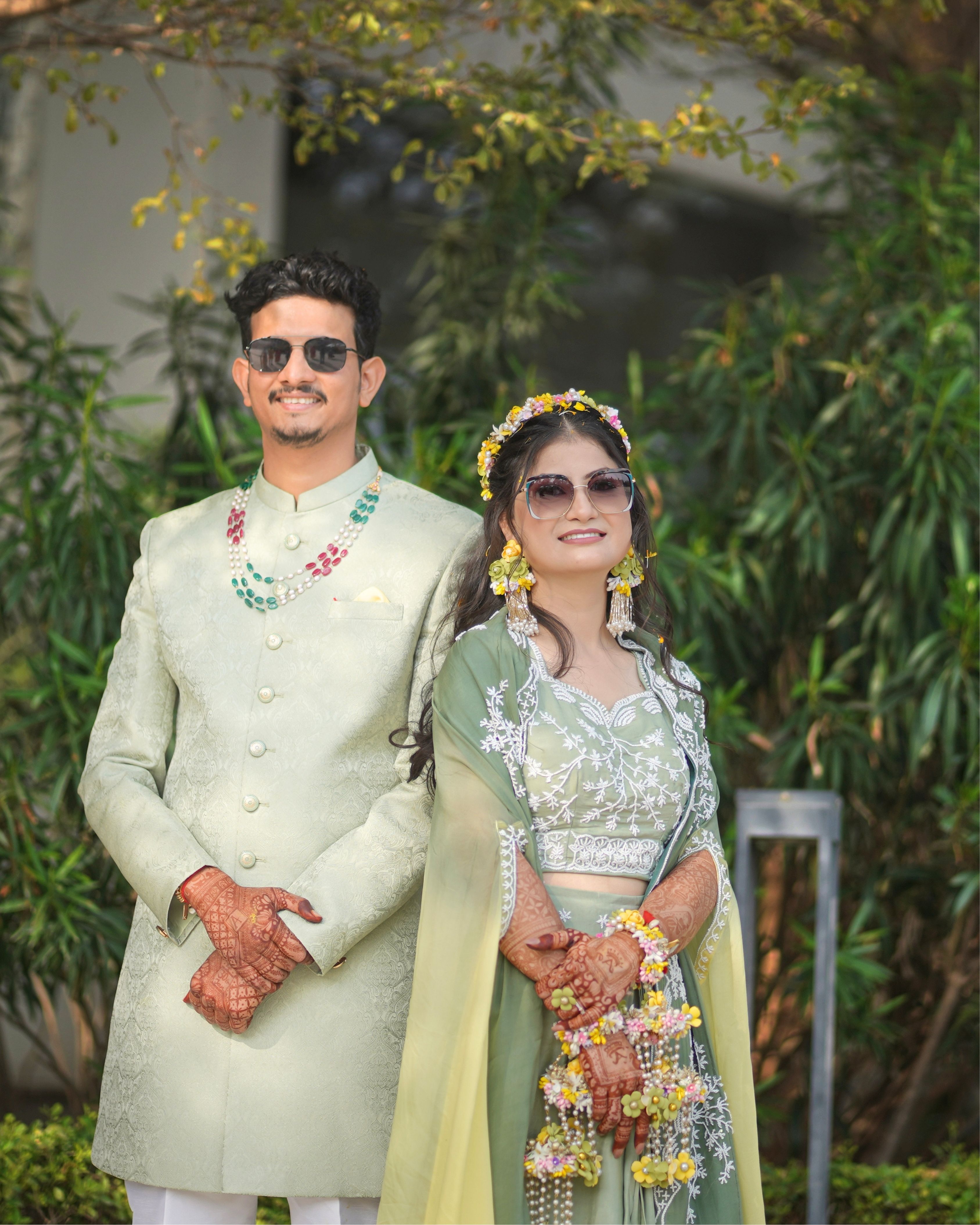 Elegant Indian couple in traditional attire, celebrating their wedding outdoors in Rajasthan.