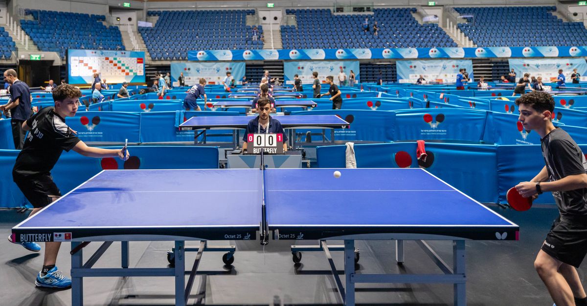 China's new Huangshi table tennis base hosts first international event as Deng Yaping praises 'Long Mang' title winners Players compete in a lively table tennis tournament in a large indoor stadium.