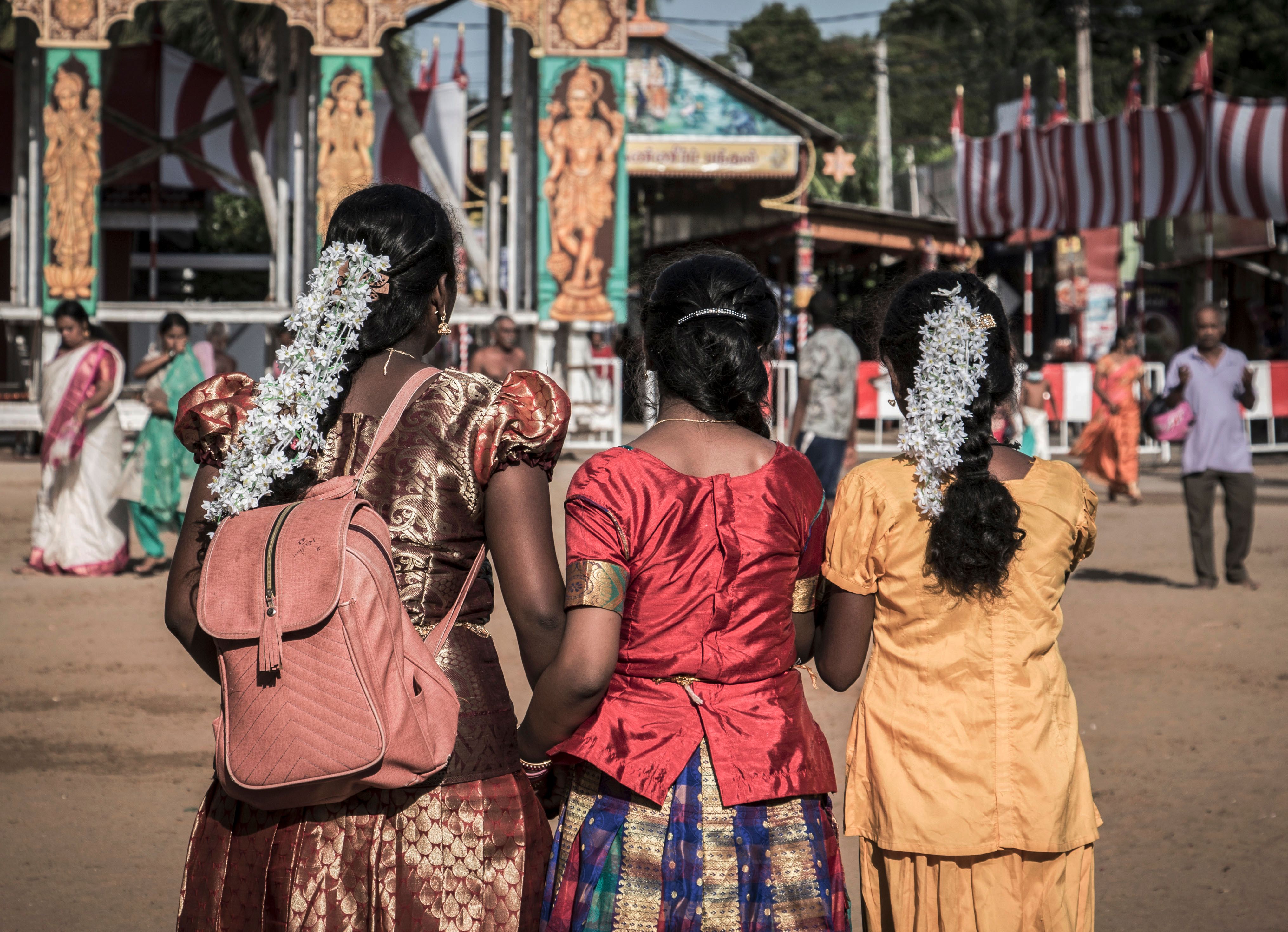 Women in vibrant traditional attire at a festive gathering in Jaffna, Sri Lanka.