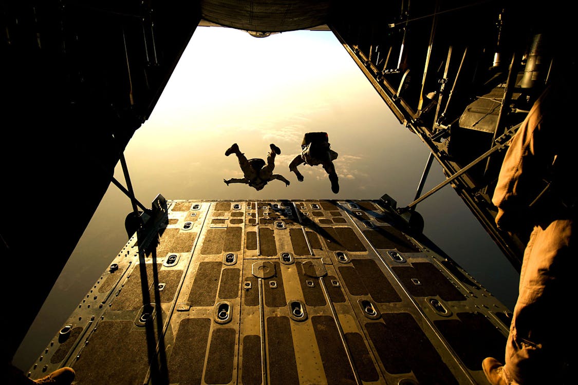 Free Parachuters Taking Off from Plane Stock Photo