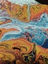 Abstract background of chaotic waves painted in different shades of blue and orange colors