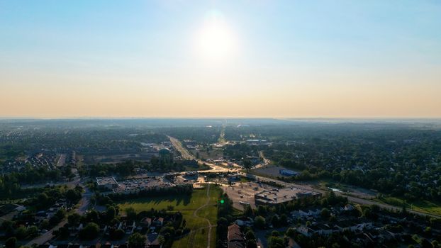 Stunning aerial view of a suburban area under a vibrant sunset sky.
