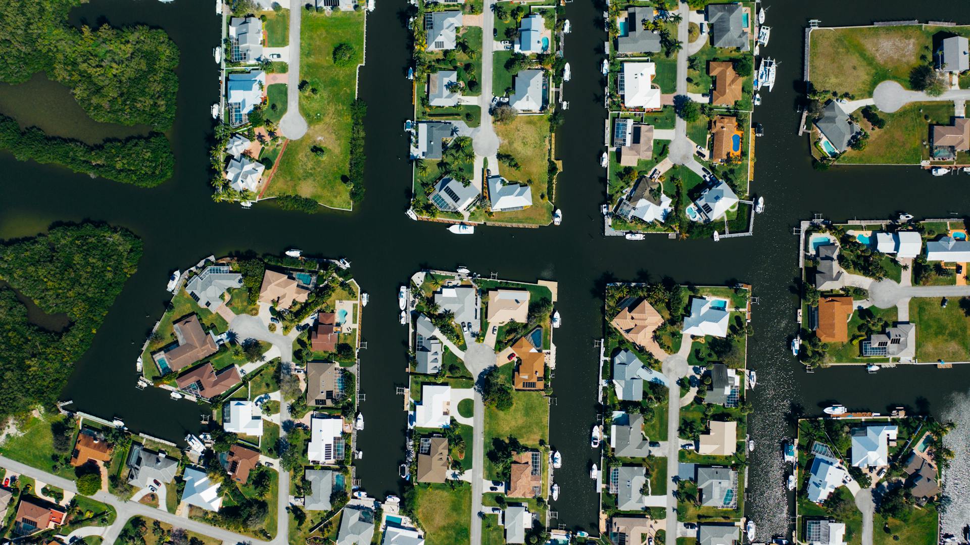 Aerial View of Houses Near Body of Water