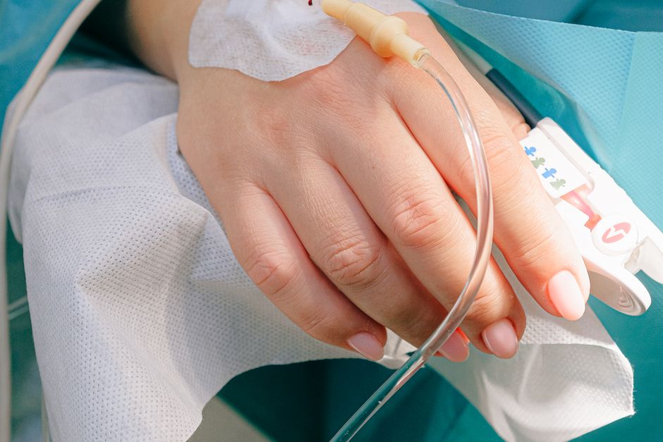 Patient receiving intravenous treatment in a clinical setting — ketamine is administered IV in approximately 40-minute sessions requiring ongoing maintenance infusions