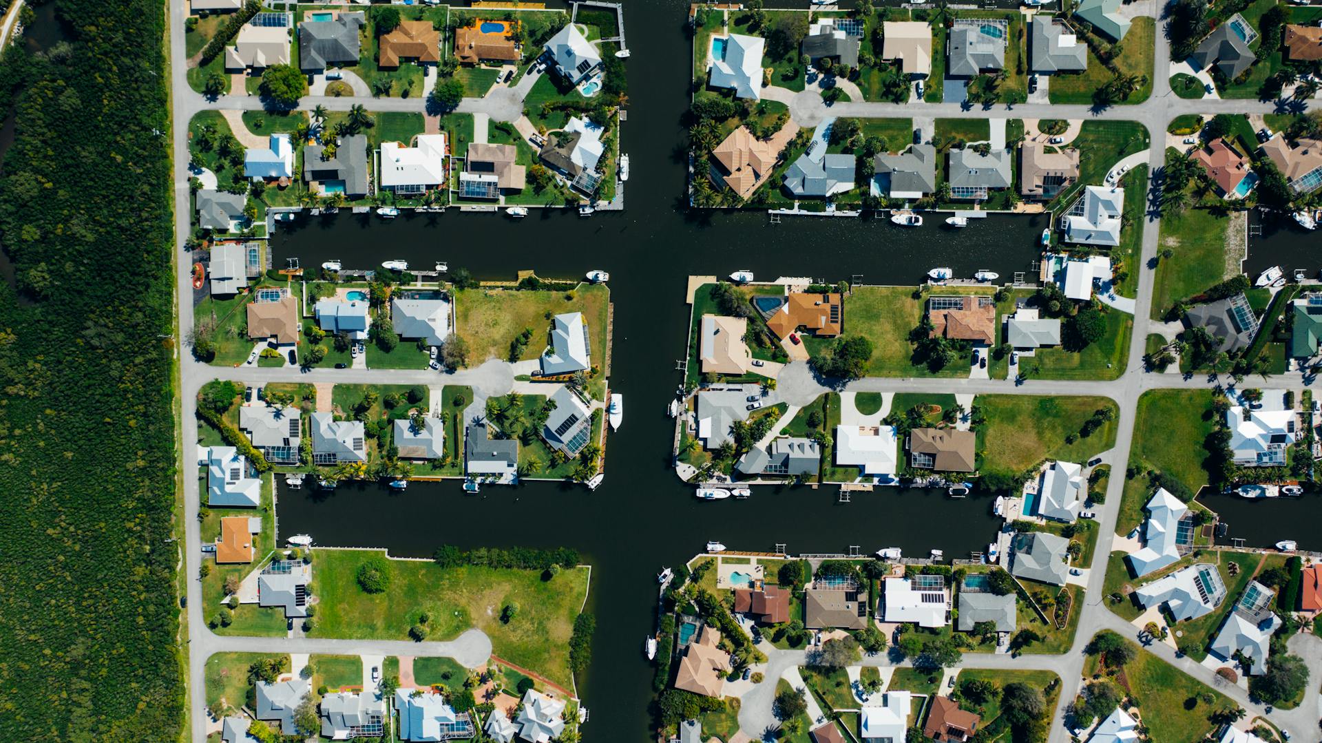 Aerial View of Houses Near Body of Water