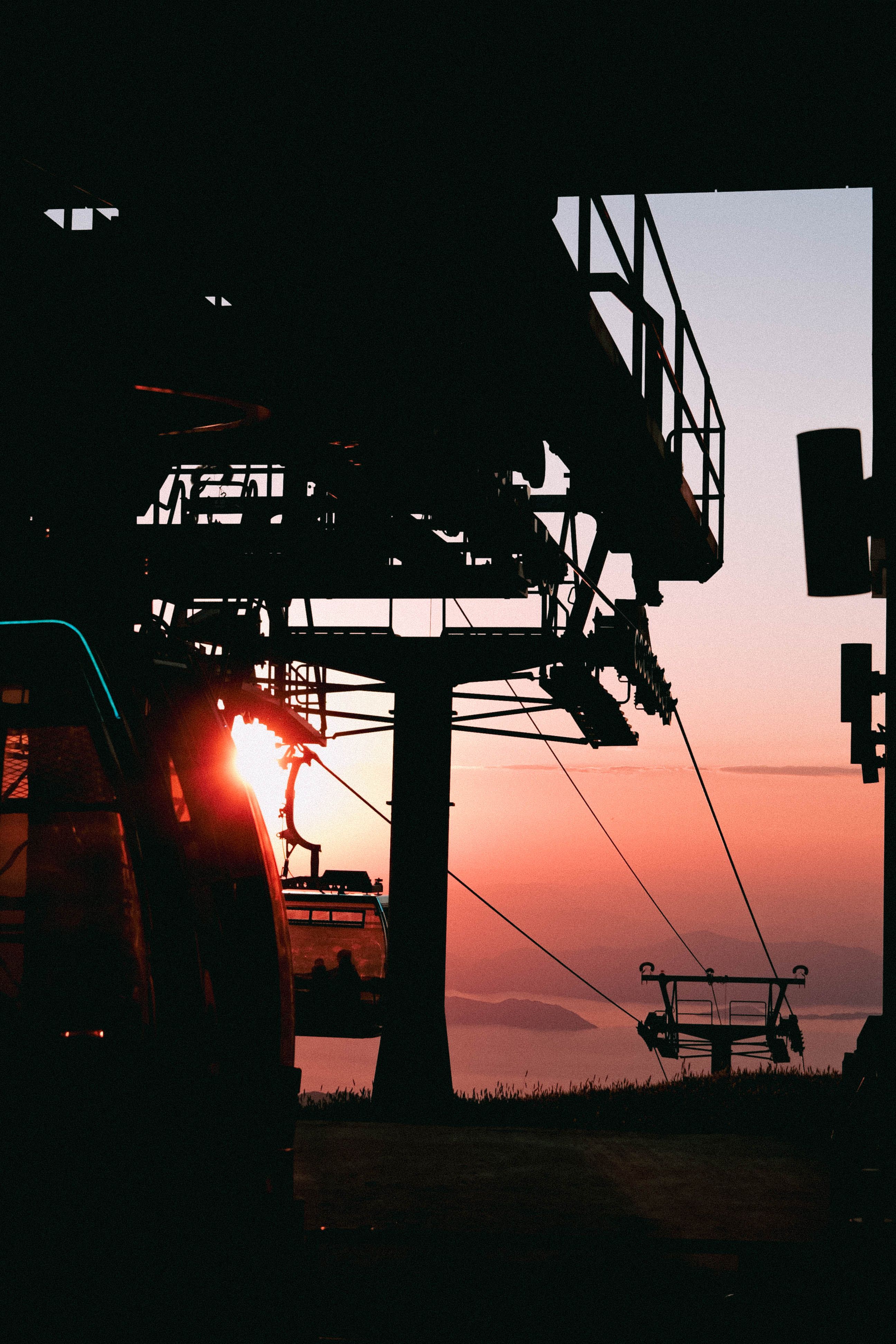 Silhouette of a chairlift at sunset in Ölüdeniz, Türkiye, capturing scenic beauty.