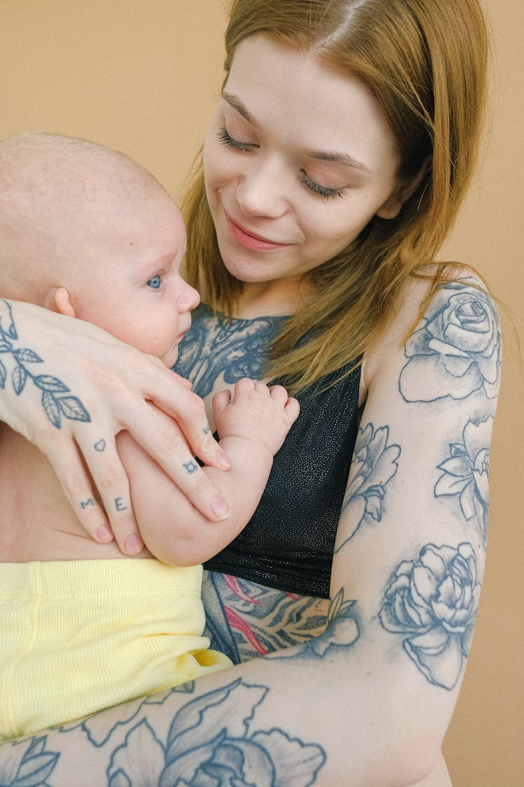 Tattooed Mother Carrying Her Cute Baby