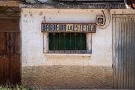 Vintage barber shop facade in Huehuetenango, featuring rustic signage and charming architecture.