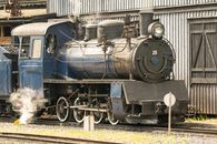 Old steam locomotive number 25 parked at a historic railway station.