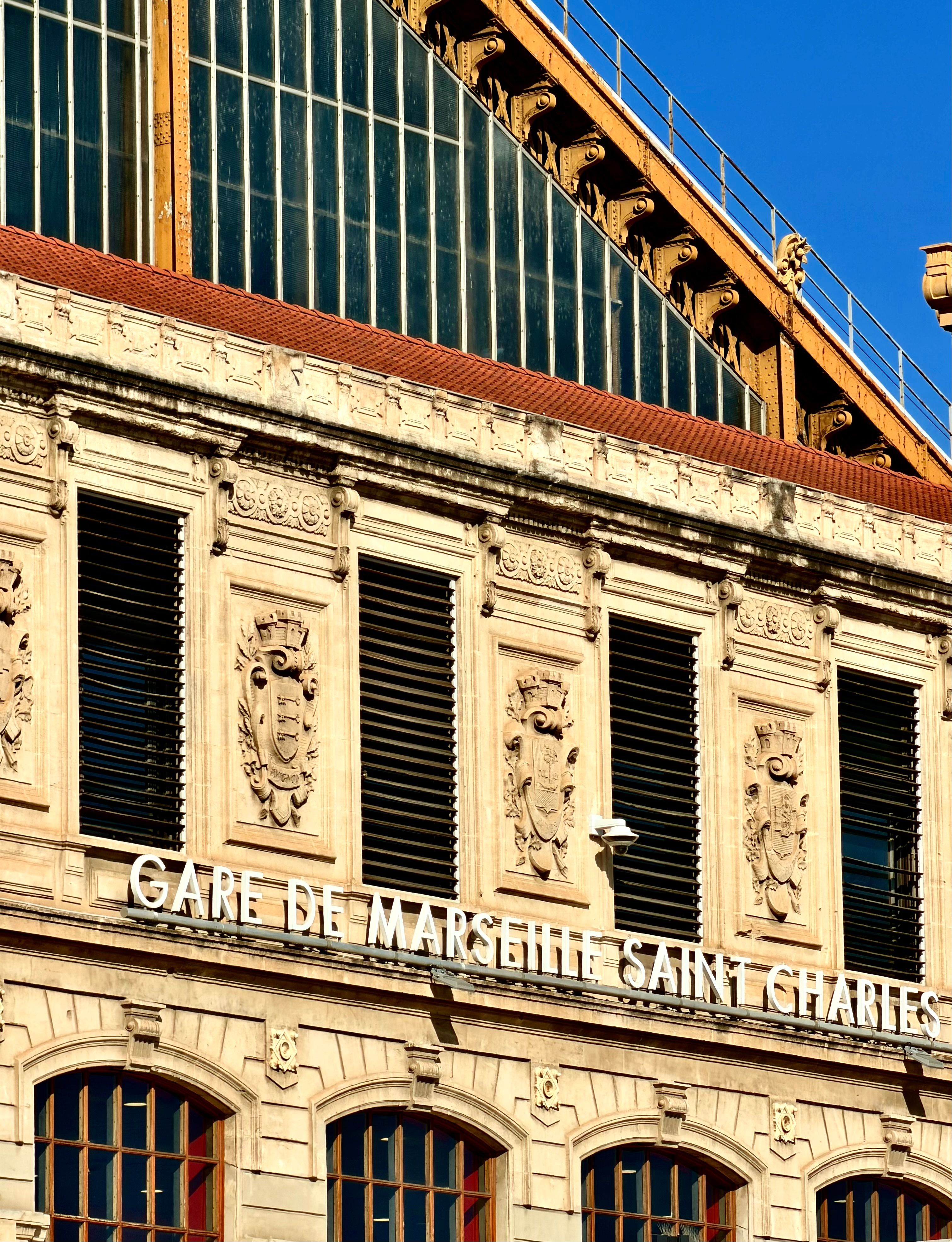 Elegant architectural details of Gare de Marseille Saint Charles captured in sunlight.