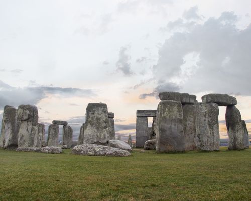 Free Iconic Stonehenge captured at sunset with a dramatic cloudy sky. Stock Photo